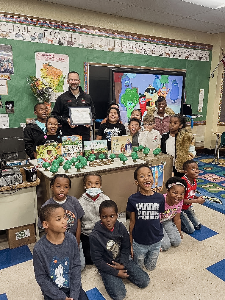 Joshua Gonzalez with his students in classroom